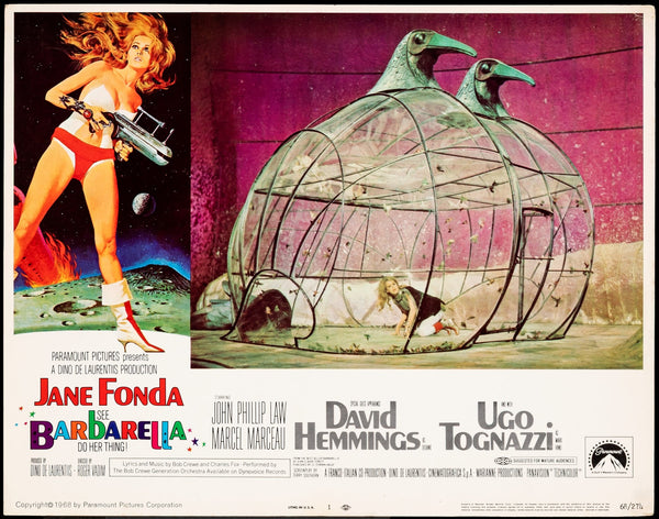 A vintage Barbarella Lobby Card displays a long-haired woman with a weapon on an alien landscape and another scene of her in a birdcage-like structure. Use the photo zoom feature to check the card’s overall condition closely.